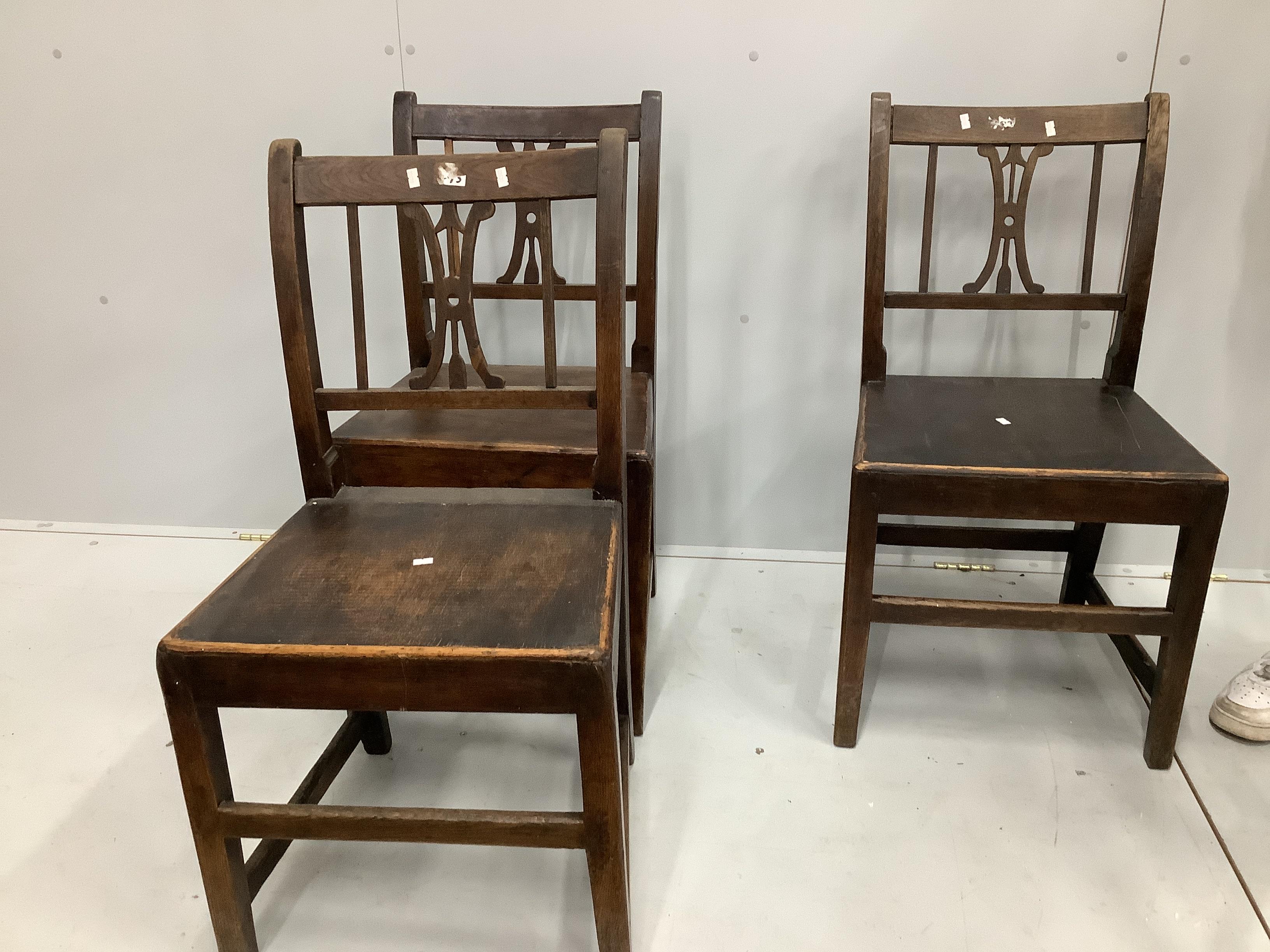 A set of four early 19th century and later provincial oak wood seat dining chairs